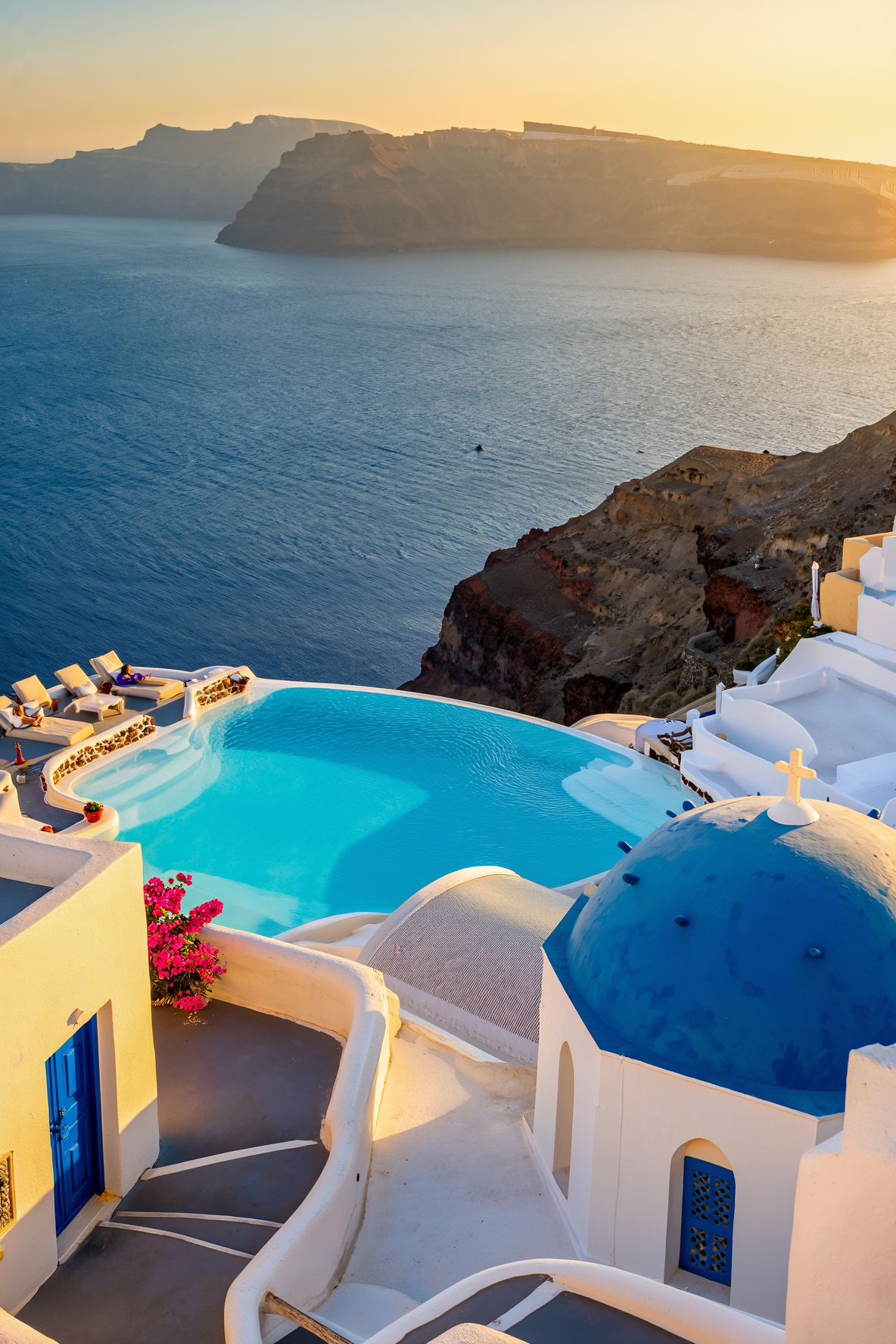 A caldera-view suite terrace in Santorini at sunset